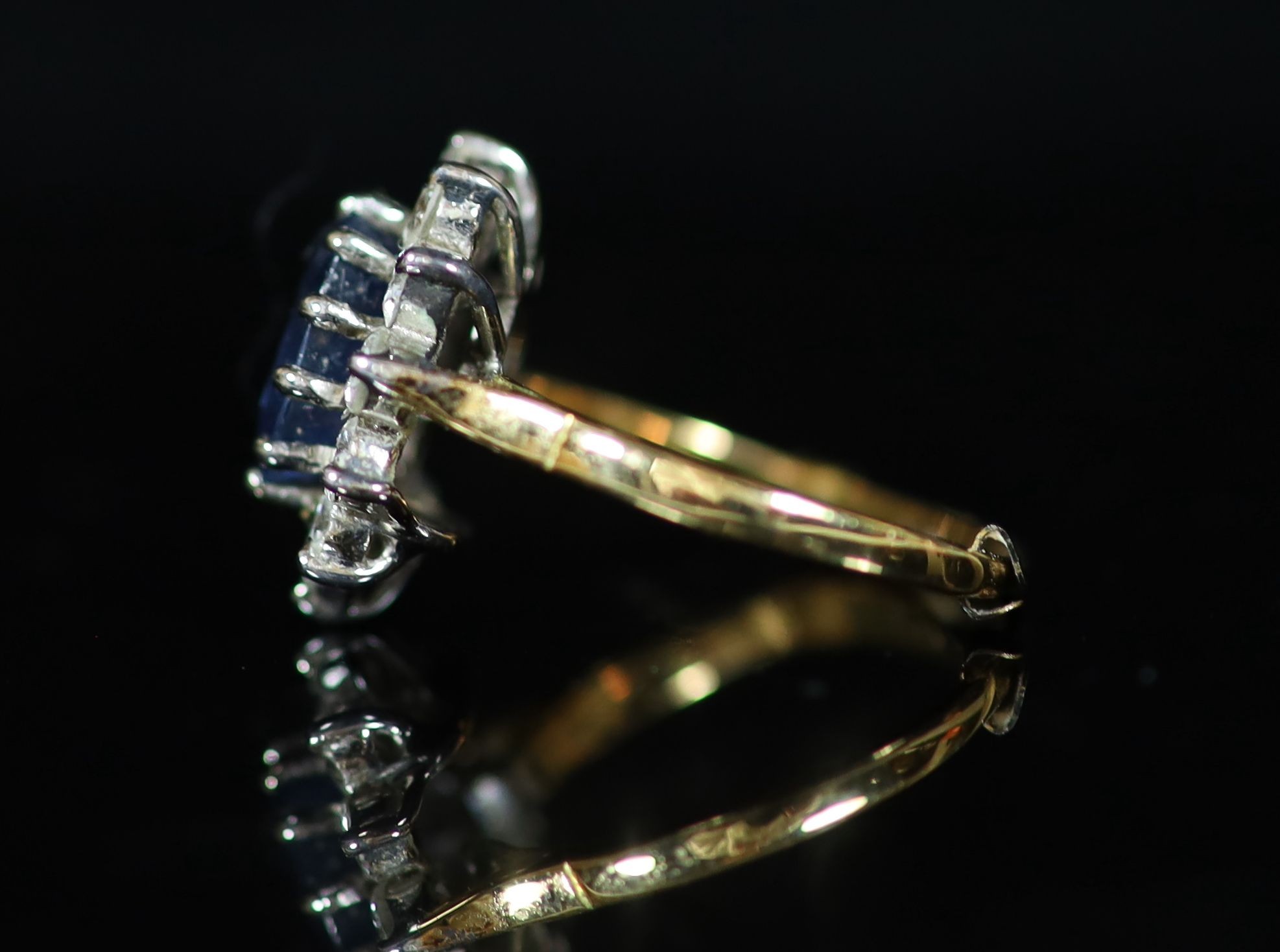 A modern 18ct gold, sapphire and diamond set oval cluster ring